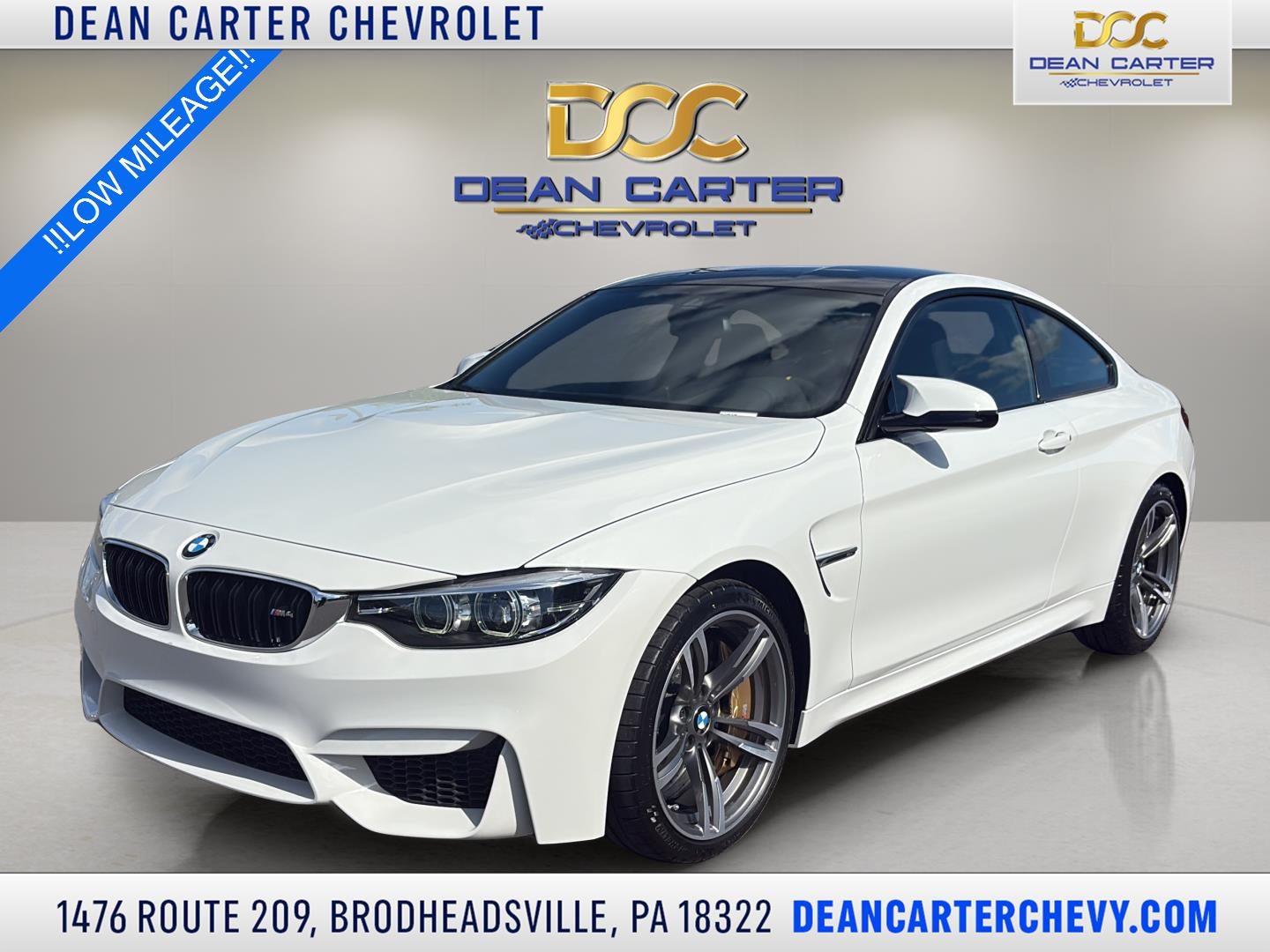 2019 BMW M4 Coupe in White — front three-quarter view